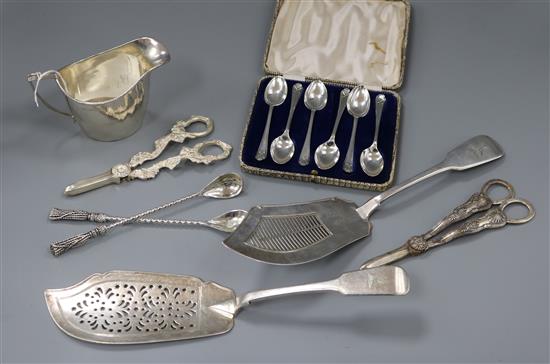 A George III silver cream jug, a George III silver fish slice, a pair of silver grape shears and five other items.